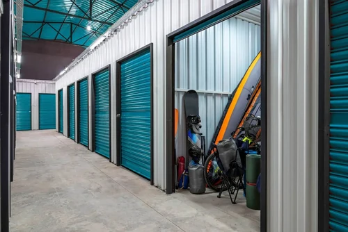 storage facility with an open storage unit displaying outdoor recreational items